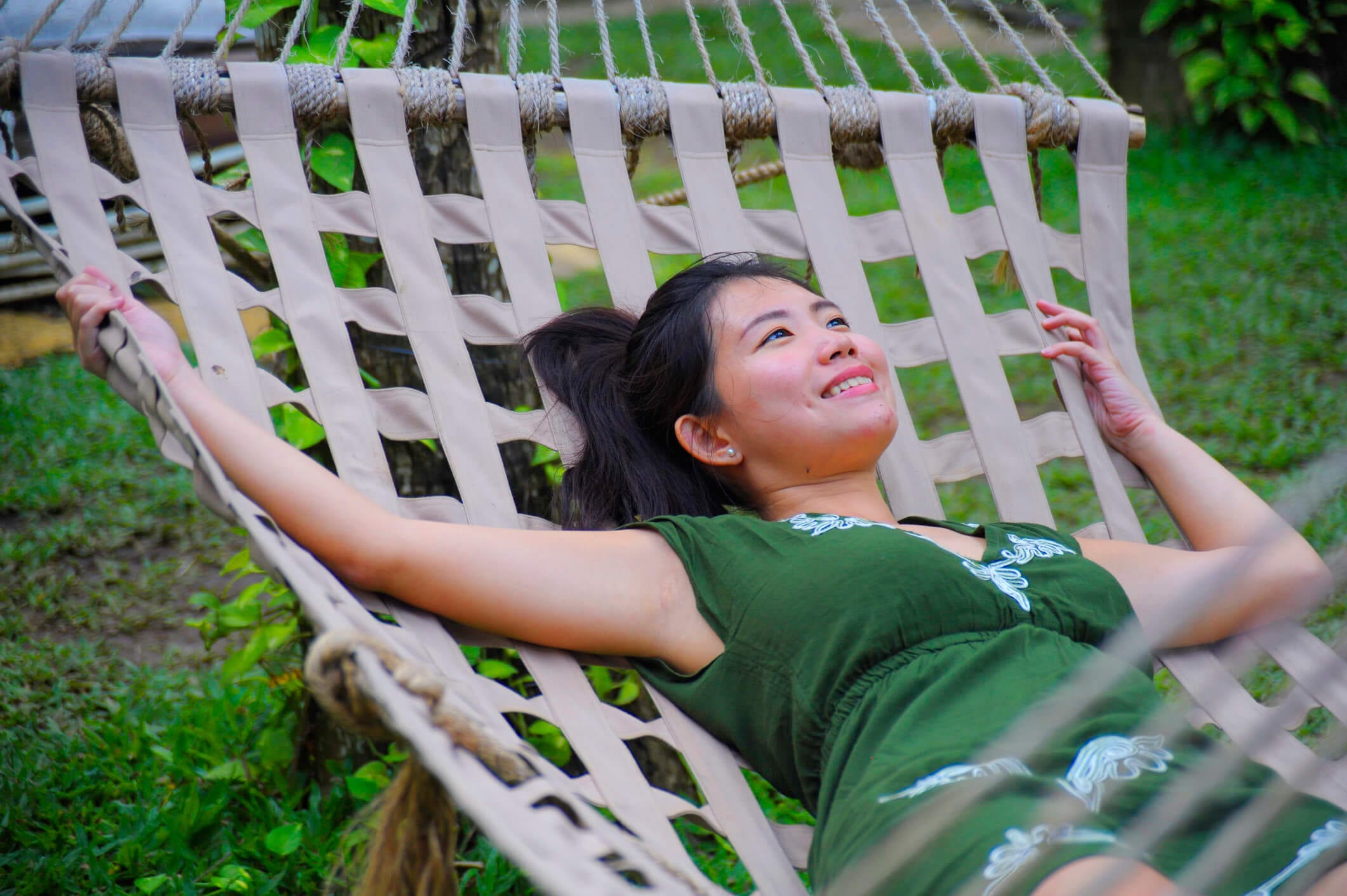 Sweet and relaxed Asian Chinese woman on her 20s wearing green